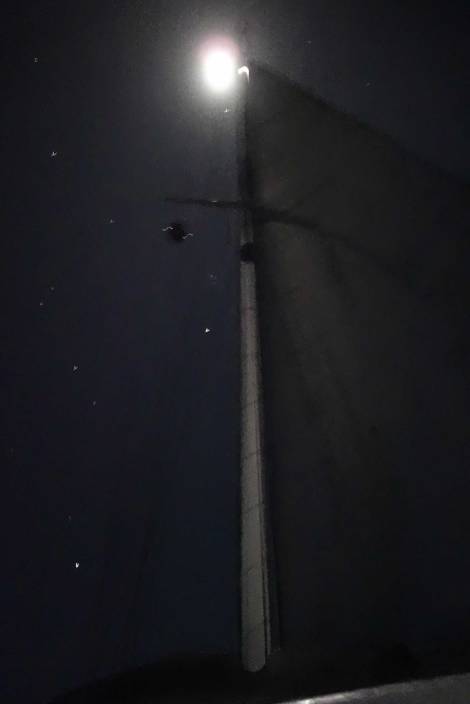 Under sail in the pale moonlight, the ocean is full of possibilities and dreams.